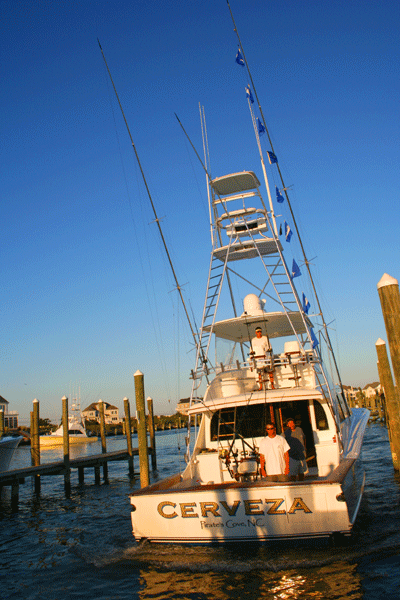 Cerveza fishing boat backing up towards the dock at sunset in OC MD